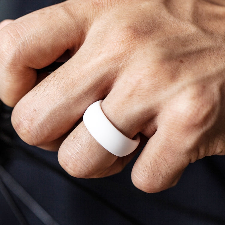 Curved white silicone sports ring on finger, smooth matte curved band