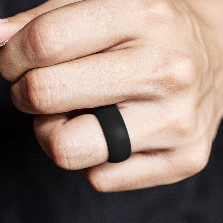 Curved black silicone sports ring on finger, matte finish