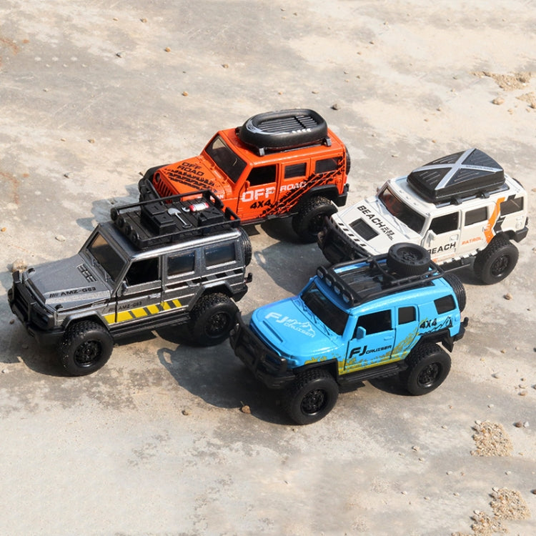 Orange, white, and blue off-road alloy toy cars grouped together with chunky tires