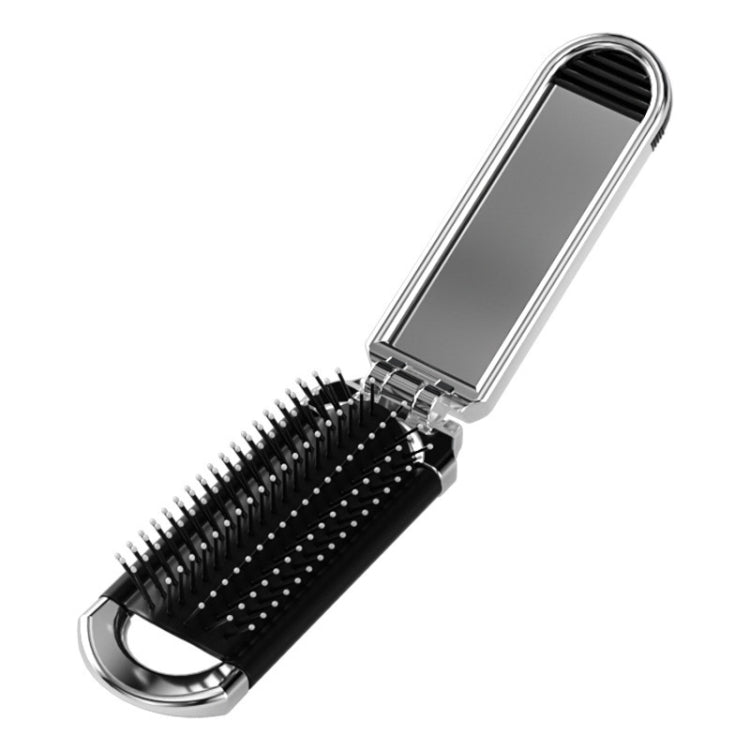 Compact foldable hair comb with black bristles and mirrored panel, silver frame