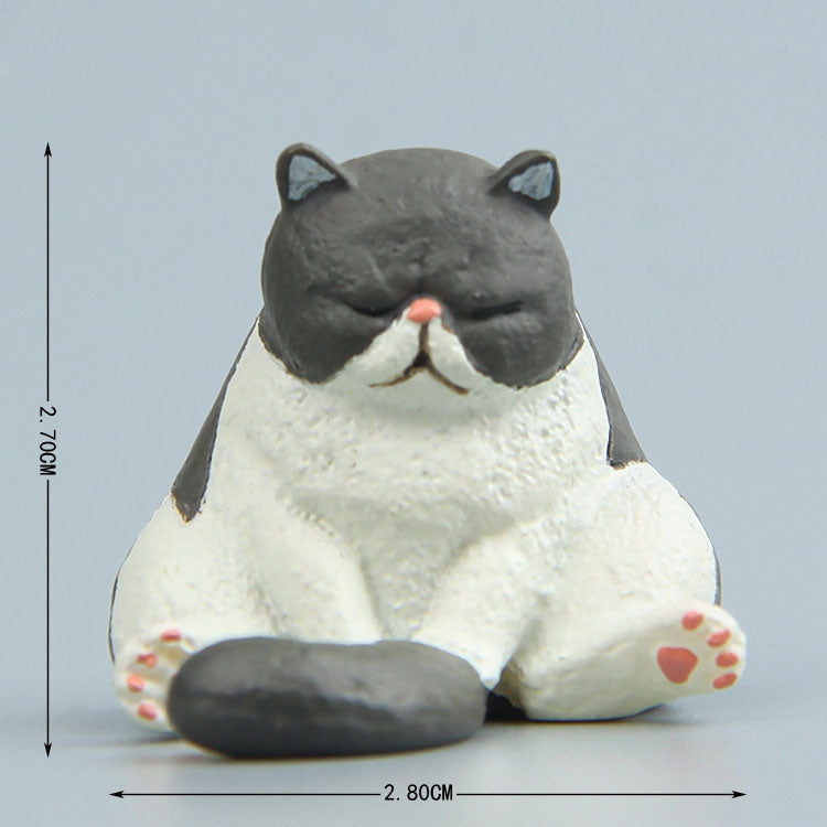 Sitting gray cat fridge magnet figure with closed eyes, white muzzle, and paws