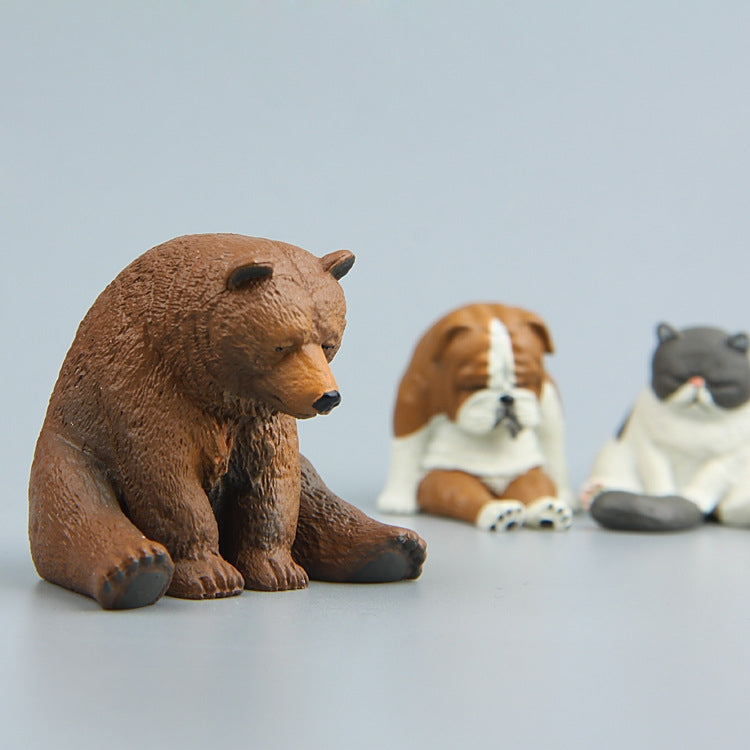 Sitting brown bear fridge magnet figure in side profile, eyes closed
