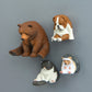 Assorted zoo fridge magnet figures: brown bear, pug dog, hedgehog, and black cat