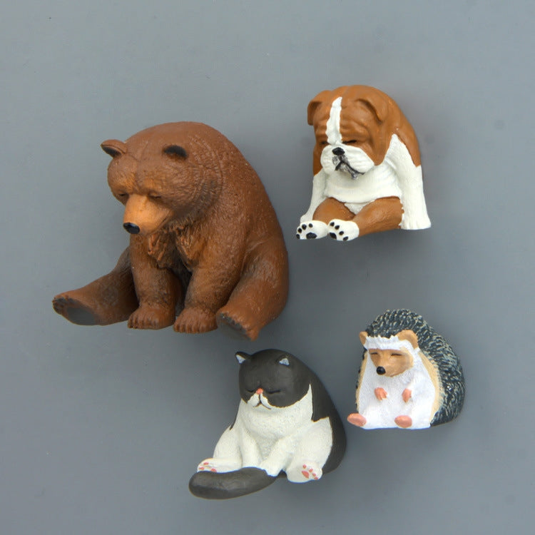 Assorted zoo fridge magnet figures: brown bear, pug dog, hedgehog, and black cat