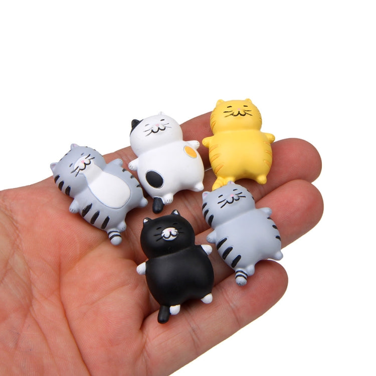 3D cat magnet stickers held in a hand, gray, black, white, and yellow