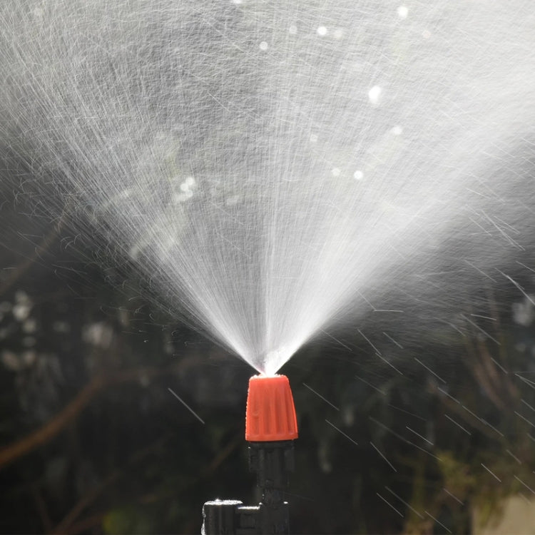 Orange drip irrigation spray head releasing a mist spray