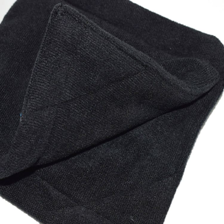 Black microfiber fleece golf ball cleaning towel close-up with stitched edge