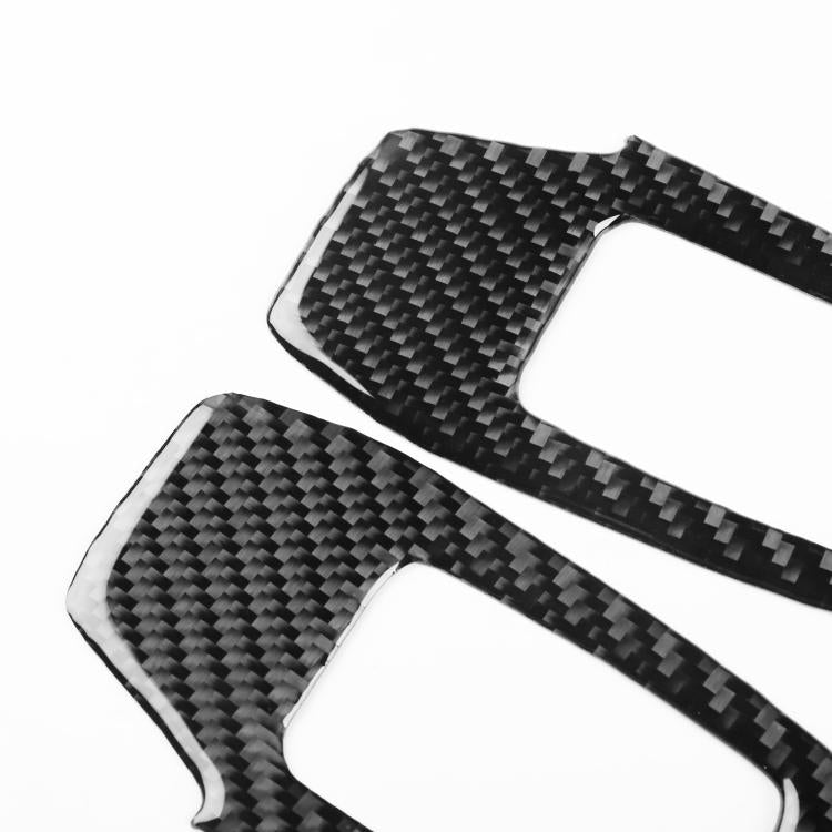 Two black carbon-fiber-style lift button sticker pieces with rounded cutouts