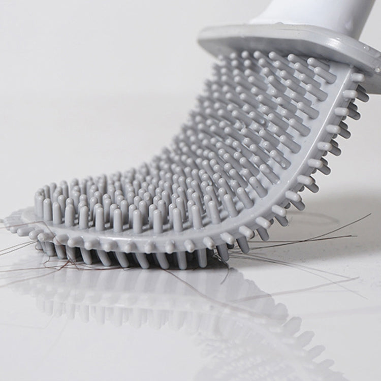 Soft rubber toilet brush head with dense gray bristles and clamp handle