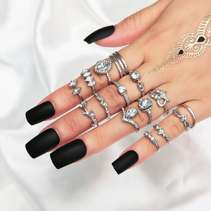 Silver-tone stackable rings with heart and water-drop rhinestone details on hand
