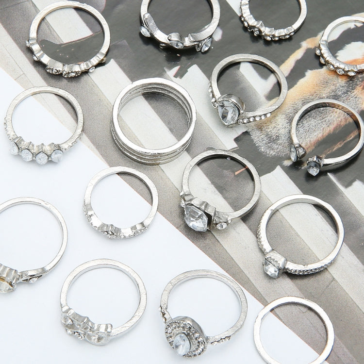 Assorted silver-tone rhinestone rings with heart and water-drop charms on display