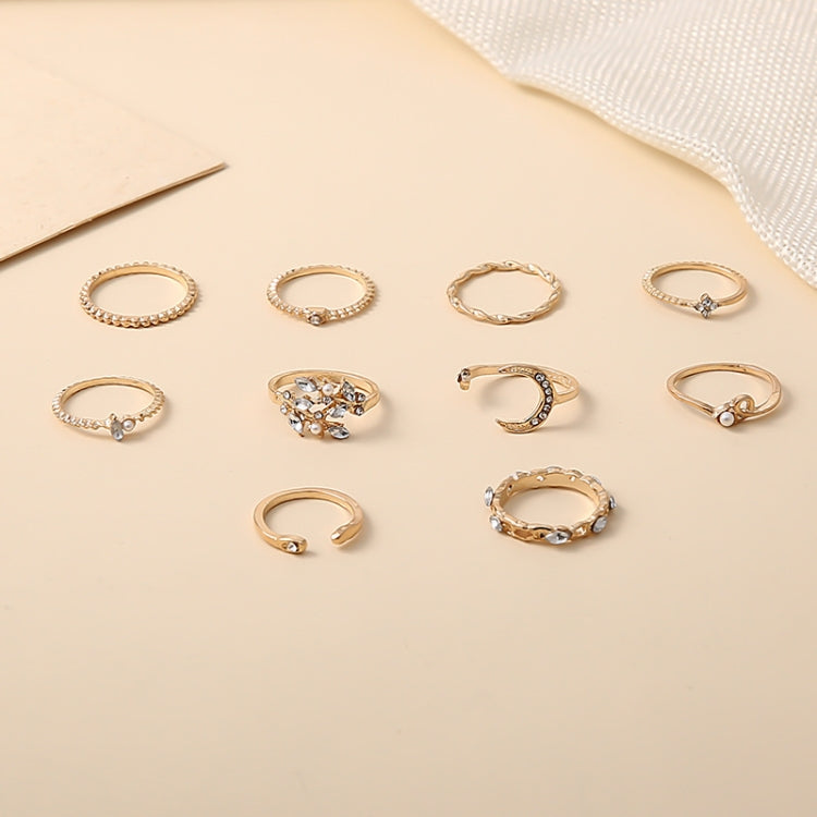 Assorted gold-tone rhinestone knuckle rings with small stones, heart and crescent shapes