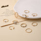 Gold-tone rhinestone knuckle rings laid on card, crescent, heart, and star motifs