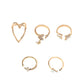 Gold-tone heart, cross, and butterfly knuckle rings set showing 5 designs