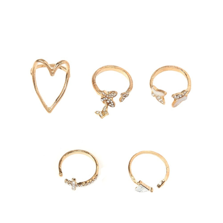 Gold-tone heart, cross, and butterfly knuckle rings set showing 5 designs