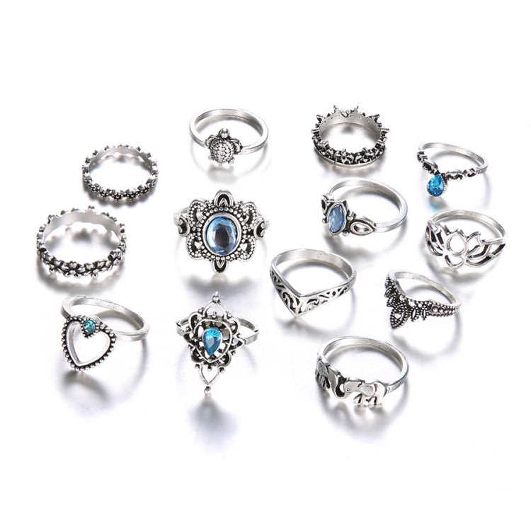 Set of 13 silver-tone rings with blue gemstone settings, assorted styles