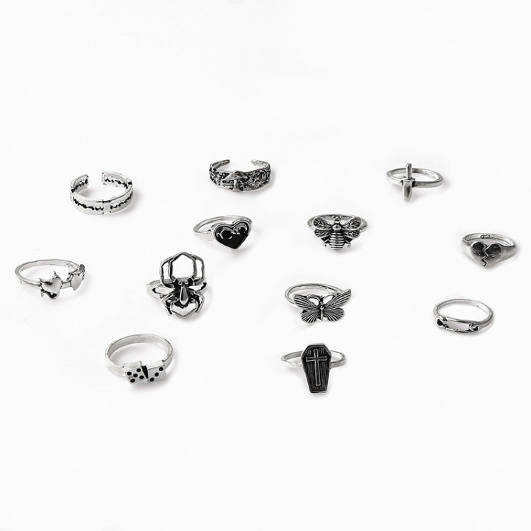 Set of open rings with assorted gothic charms, including cross, butterfly, dice, and spider