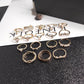 Gold-tone ring set with multiple crystal and pearl-like stone designs, 17 rings