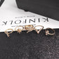 Gold-tone boho rings with pink opal-like stones and crystal settings, set view