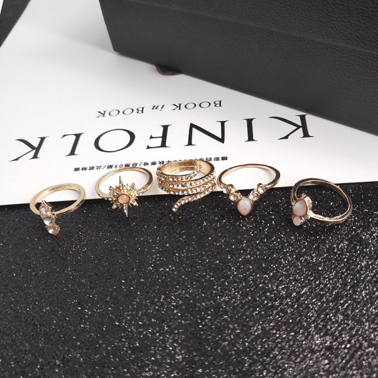 Gold-tone boho rings with pink opal-like stones and crystal settings, set view