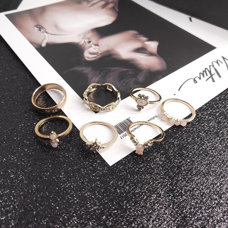 Gold-tone statement rings with heart and gemstone designs, mixed opal-like stones