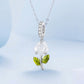 Sterling silver necklace with hanging white rose charm and green enamel leaf accents