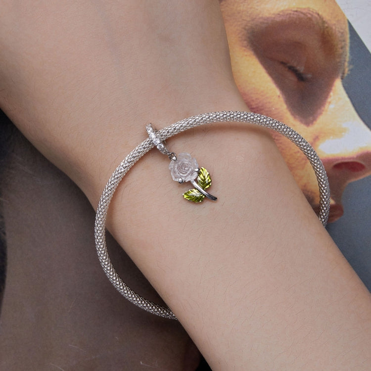 Sterling silver charm bracelet with rose pendant, white petals and green enamel leaves