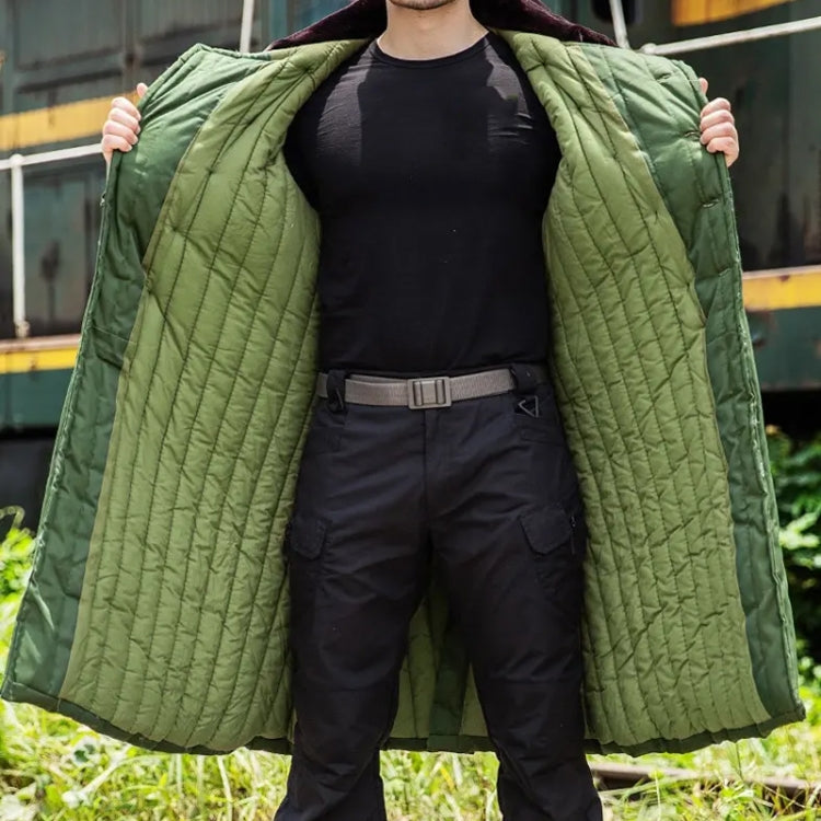 Green hooded quilted cotton coat worn over black top and pants, open front view