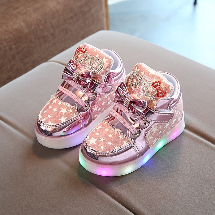 Kids light-up sneakers in pink with star pattern, bow accents, flashing LED soles