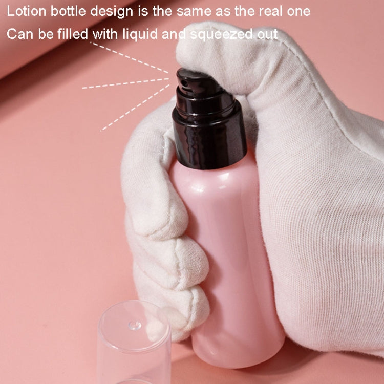 Girls makeup play set: toy lotion bottle with clear cap, held in a gloved hand