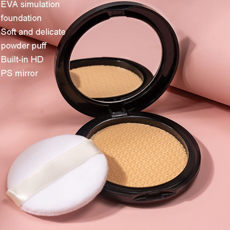 Round powder compact with beige powder and white puff pad