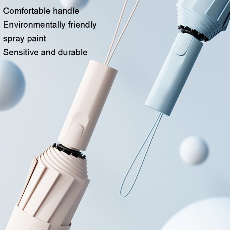 Beige automatic umbrella handle with wrist strap, shown closed