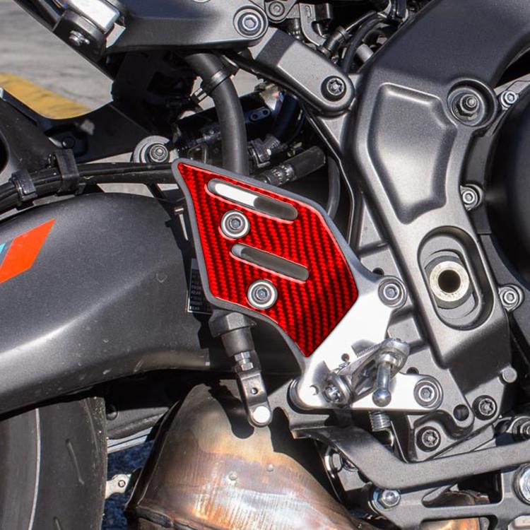 Red carbon-fiber footpad stickers on motorcycle side panel, two-piece set