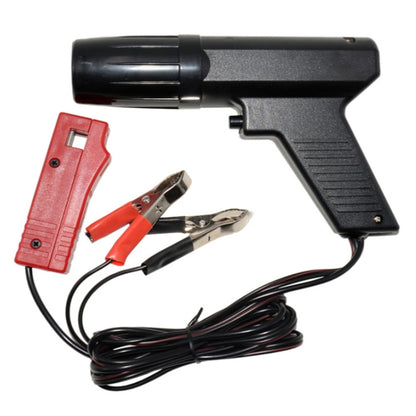 Gun-type timing light with black body, red connector, and black wire test leads