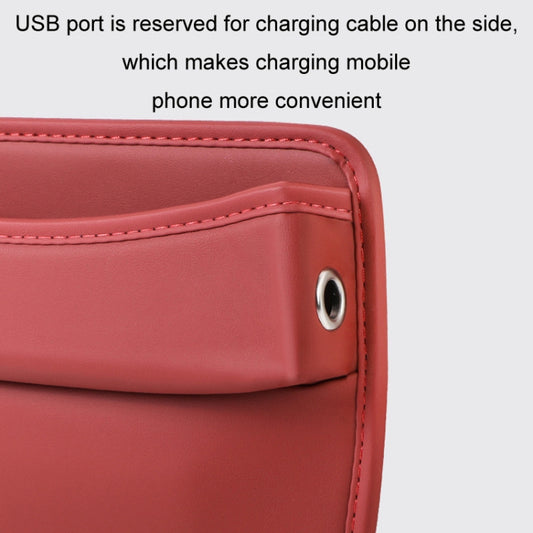 Red car seat gap storage organizer pouch with stitched seam and round grommet on side.