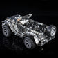 Metal off-road vehicle model toy with silver body panels and large black tires, rear 3/4 view