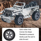 Metal off-road vehicle model toy with silver construction and black tread tires, outdoor angled view
