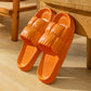 Orange EVA couple slippers, slip-on design with ridged footbed and grippy texture, pair