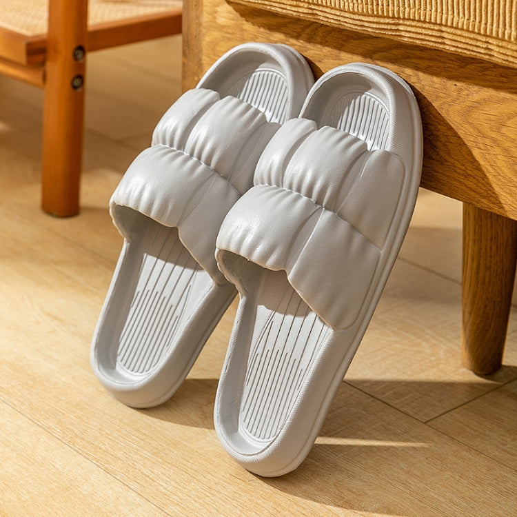 White EVA slide slippers, padded crossover straps and ridged insole with thick sole