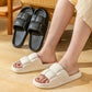 Cream and black slide slippers with cushioned straps and open toe