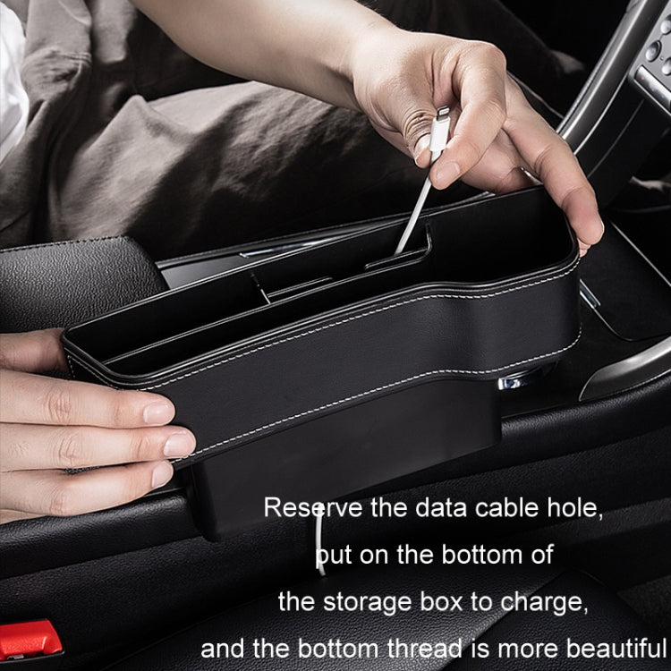 Black leather-look storage box installed in car seat with top cable pass-through