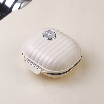 White textured portable medicine dispensing box with round metal clasp