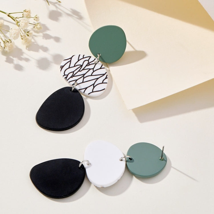 Long dangle earrings: teal circles with white leaf-print and black oval drops