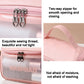 Pink frosted cosmetic bag close-up with double zipper pulls and stitched trim