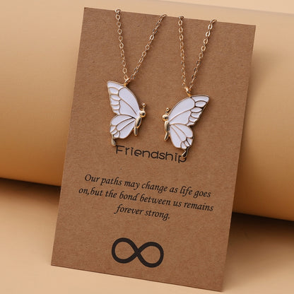 Gold butterfly pendant necklace with linked chain and two white enamel butterfly charms