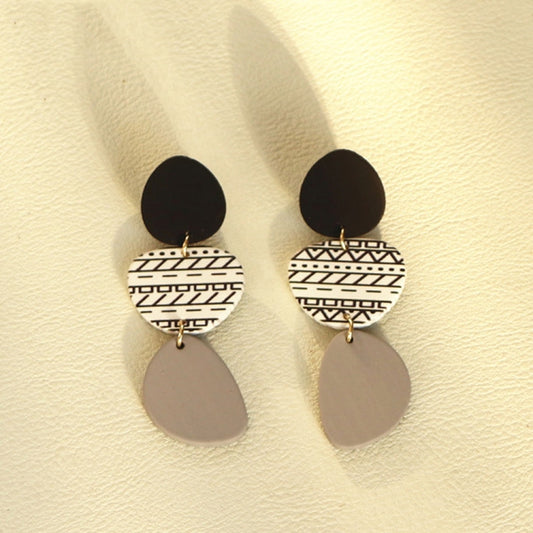 Long acrylic drop earrings with black top, white geometric middle, gray oval dangles