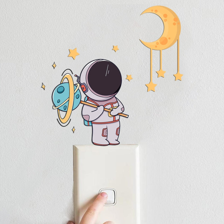 Astronaut and crescent moon glow wall stickers above a light switch