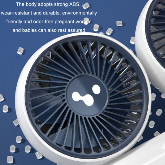 Close-up of double-head car fan grille with central fan logo on a dark housing