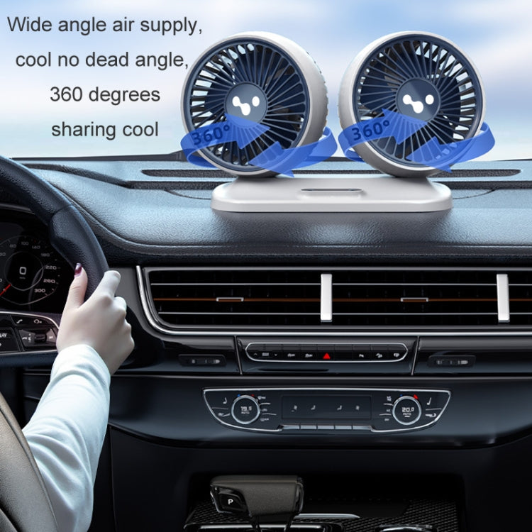 Double-head car fan mounted on a dashboard vent area with wide airflow coverage