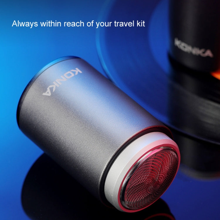 Portable electric shaver head close-up with red ring and round metal foil